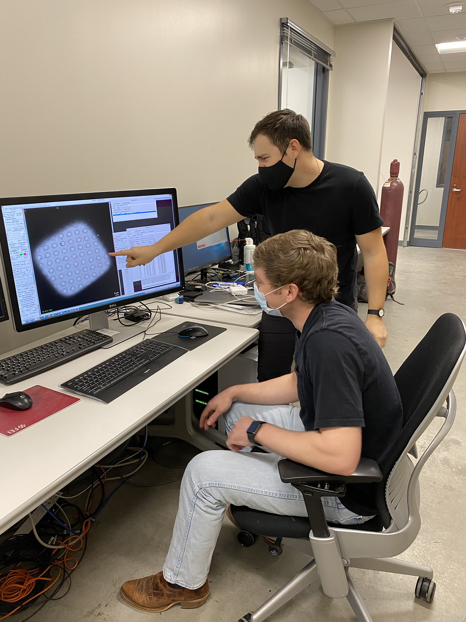 Jack Bravo and Tyler Dangerfield use a cryo-EM microscope